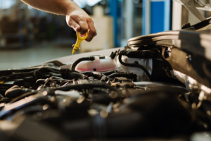 Pouring Oil to Car Engine. Fresh Oil Poured during an Oil Change